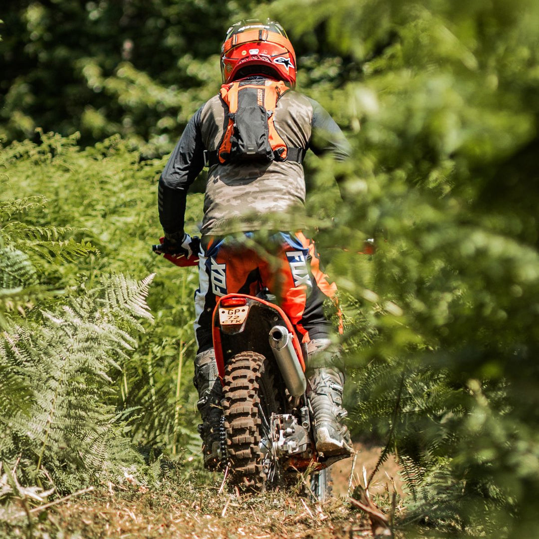 Rider entering forest trail on enduro bike at Machinehead Moto Off-Road, Surrey