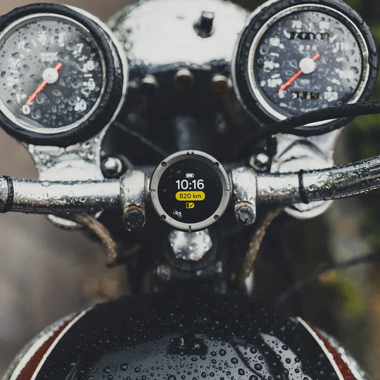 Beeline Moto II waterproof motorcycle navigation device on vintage handlebars showing ride data with time and distance