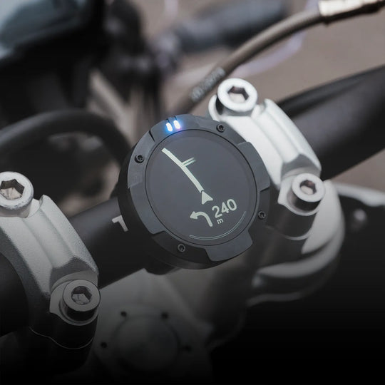 Beeline Moto II mounted on motorcycle handlebars showing left turn navigation in 240 metres with LED indicator