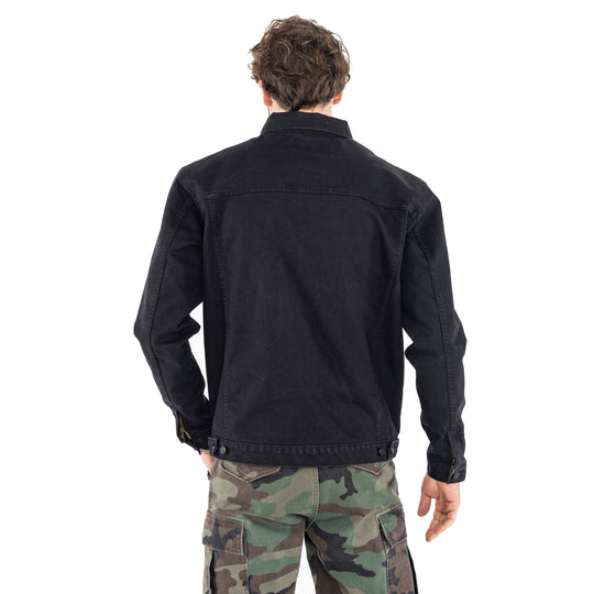 Man wearing the John Doe Maverick jacket in Black Raw and Defender trousers in camo – rear view