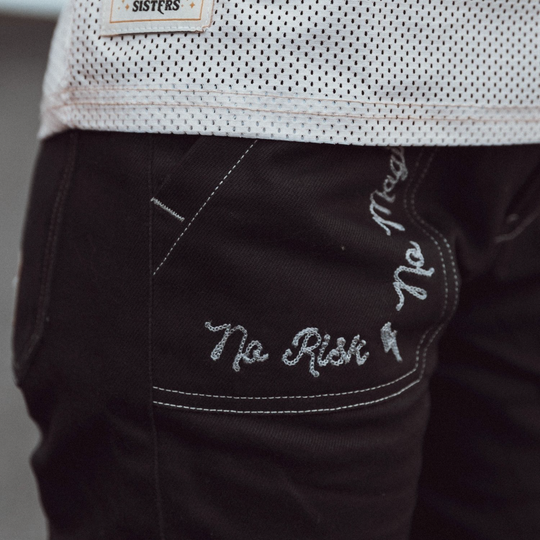 Wildust Sisters Cargo Overland Trousers – close-up of silver embroidery on black cargo pocket