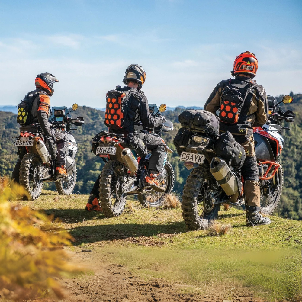 Riders wearing Kriega-T9 backpacks overlooking hillside