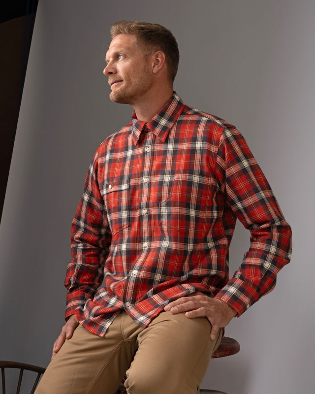 Pike Brothers 1937 Roamer Shirt in Red Flannel shown in a seated pose