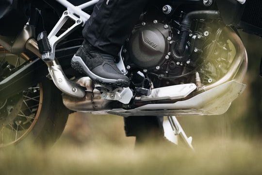 Boundless H2O ADV Footwear close-up worn on an adventure motorcycle footpeg.

