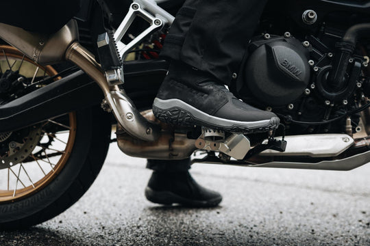Boundless H2O ADV Footwear close-up worn on the footpeg of an adventure motorcycle.