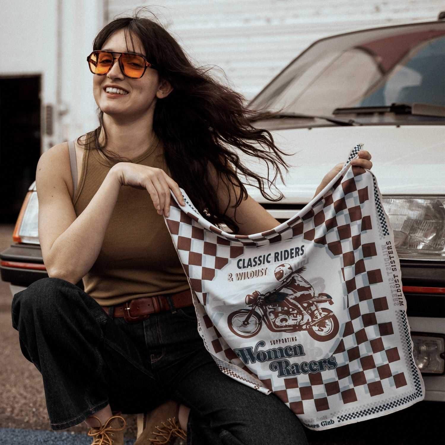 model-holding-wildust-sisters-classic-scarf-chequered-vintage-pattern-motorbike-artwork-brown-side