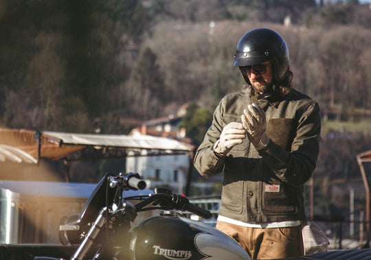 Rider wearing Age Of Glory Craftsman Jacket in Olive and Black Motorcycle Helmet
