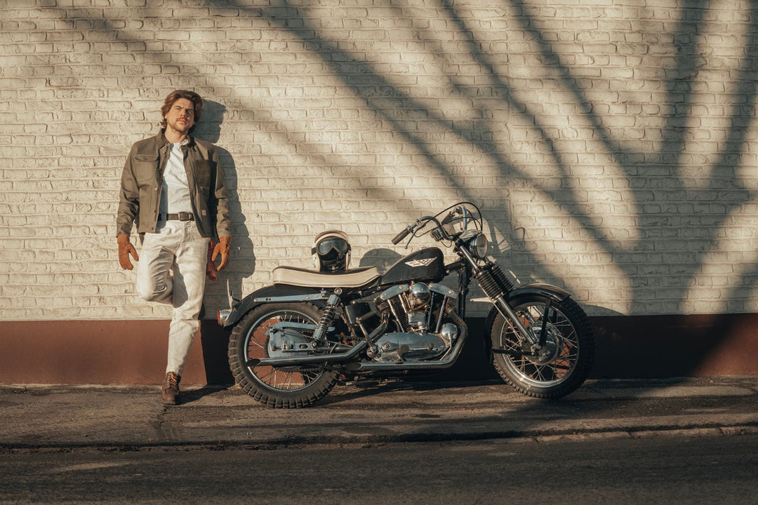 Model Wearing Age Of Glory Craftsman Jacket in Olive Front View, with Motorcycle
