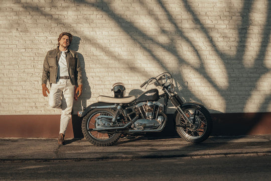 Model Wearing Age Of Glory Craftsman Jacket in Olive Front View, with Motorcycle