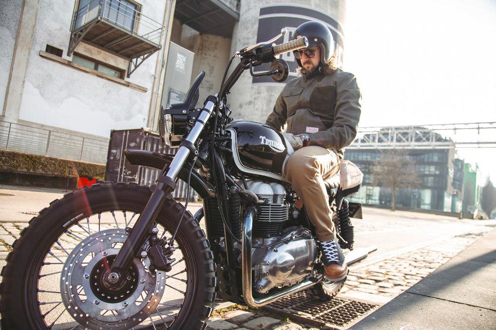 Model sat on Motorcycle wearing Age Of Glory Craftsman Jacket in Olive