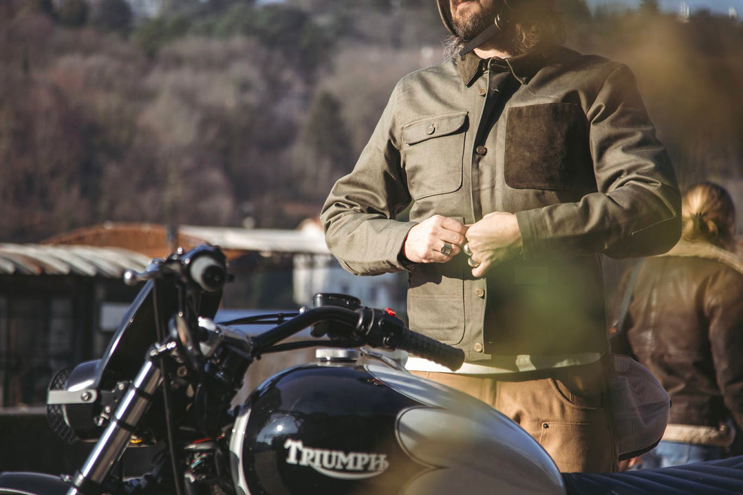 Model Wearing Age Of Glory Craftsman Jacket in Olive, 3/4 View, and Pockets With Motorcycle