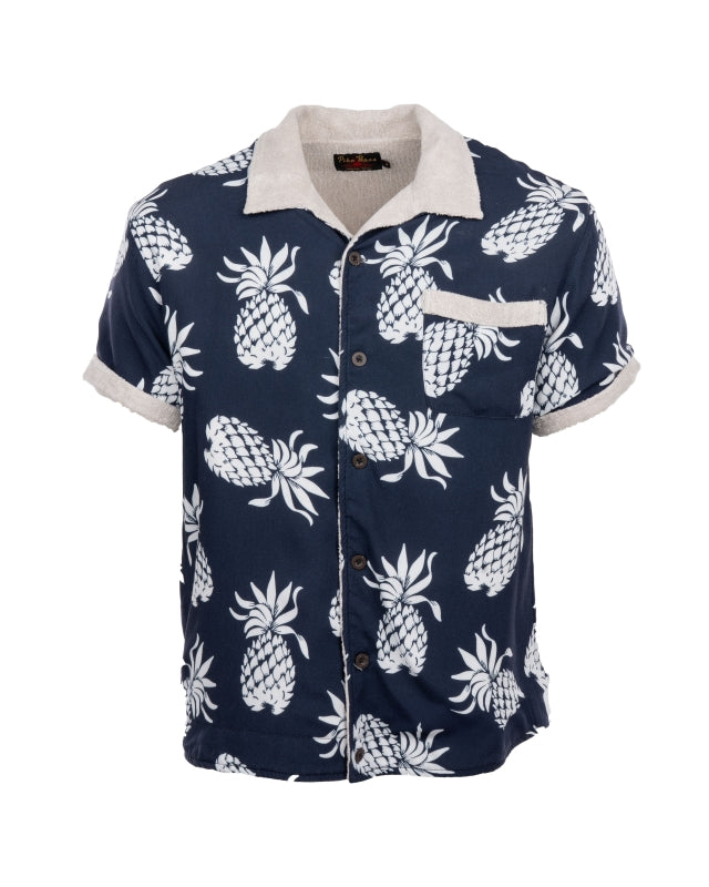 Flat lay of Pike Brothers 1961 Cabana Shirt in Entrega Blue with retro pineapple print and towelling trim