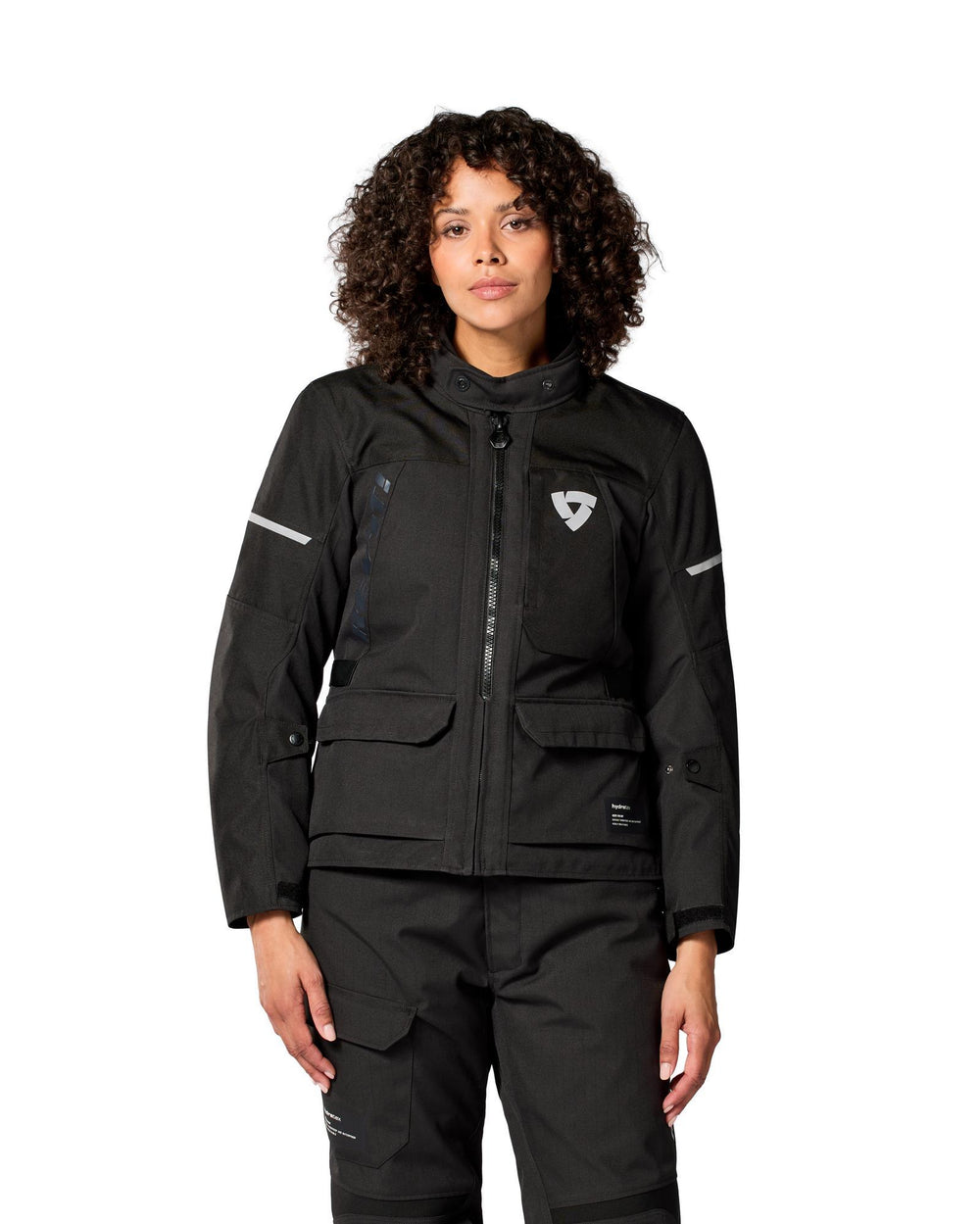 Woman wearing black REV'IT! Convergent H2O Ladies Adventure Motorcycle Jacket, front view
