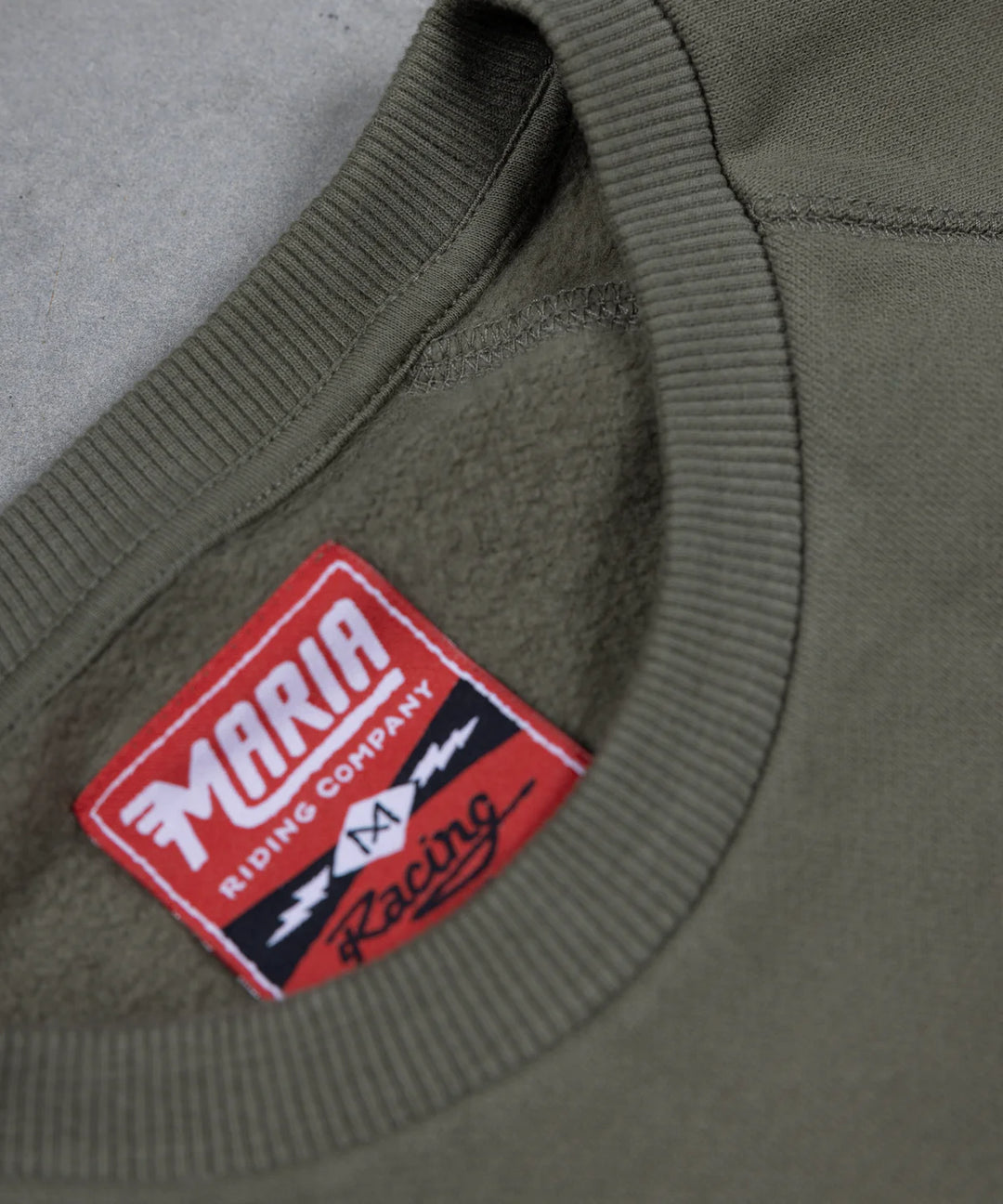 Maria-riding-spades-sweatshirt-army-green-neck-label