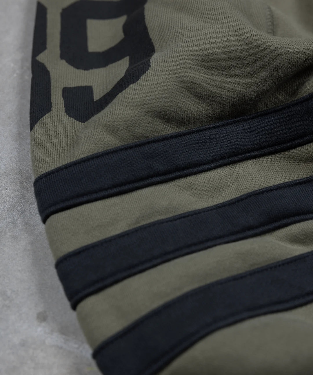 Maria-riding-spades-sweatshirt-army-green-sleeve-stripes
