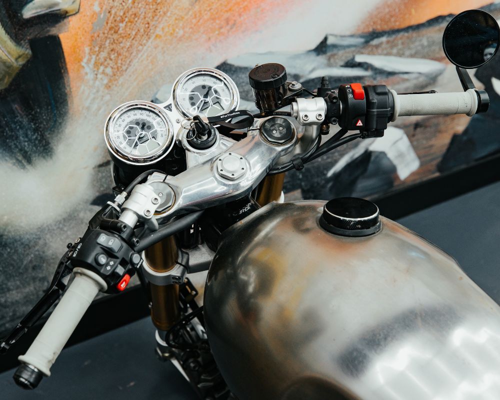 Close-up of handlebar and speedo setup — available as a rider fit adjustment on all bikes at Machinehead Moto