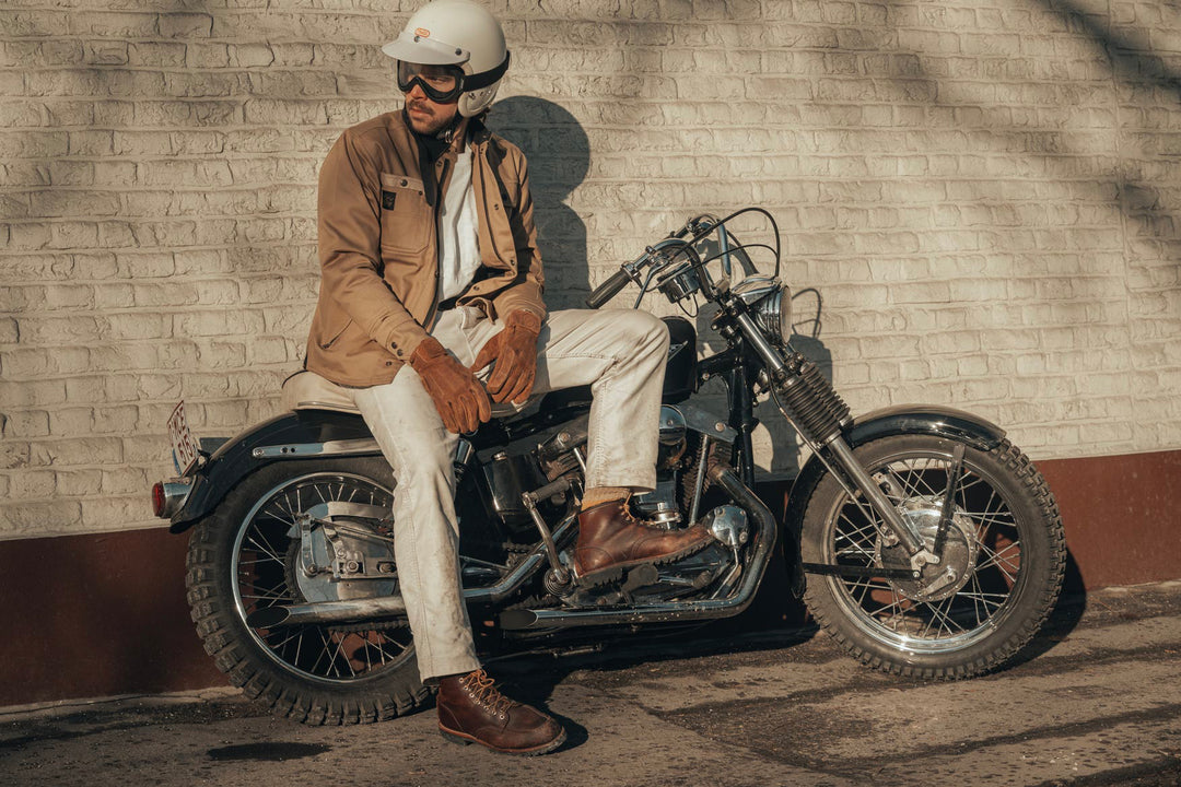 Age of Glory Runaway Riding Shirt in Desert Khaki – Rider Sat on Motorcycle, against wall