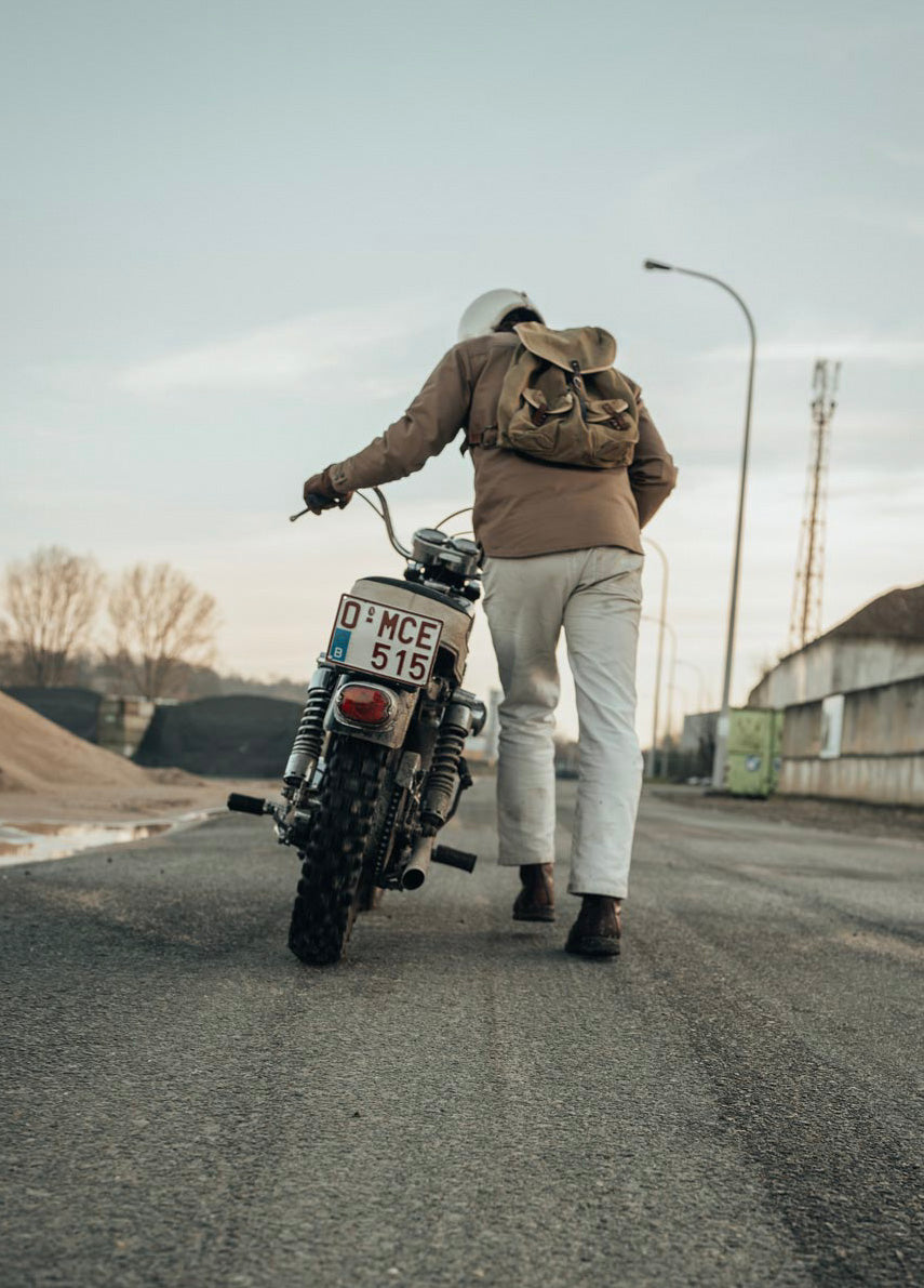 Age of Glory Runaway Riding Shirt in Desert Khaki – Rider Pushing Motorcycle, Back View