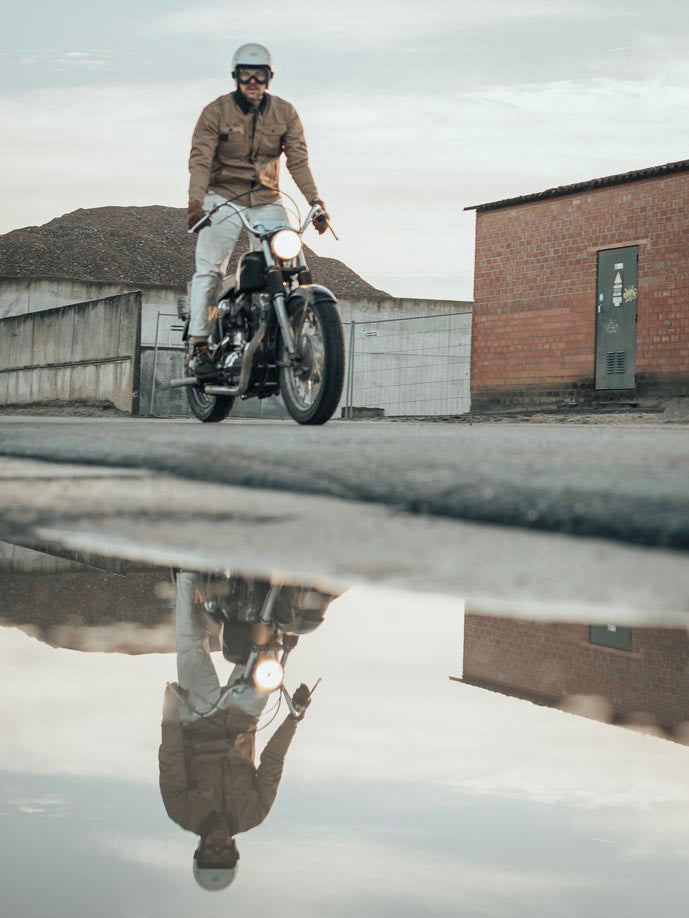 Age of Glory Runaway Riding Shirt in Desert Khaki – Rider Standing on Motorcycle, Front View