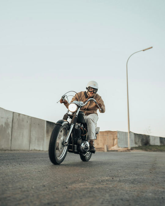 Age of Glory Runaway Riding Shirt in Desert Khaki – Rider on Motorcycle, Front View Holding Handle Bars