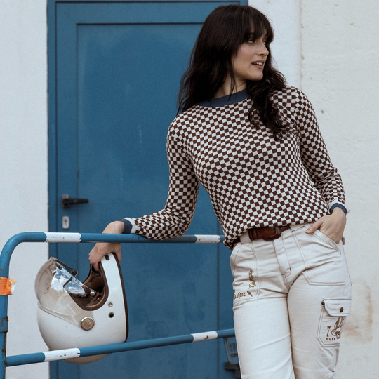 model-holding-helmet-wildust-sisters-jumper-classics-front