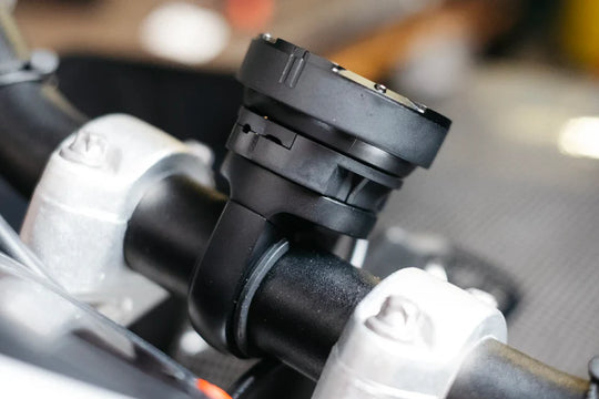 Beeline Moto II Powered Mount installed on motorcycle handlebars, side view close-up