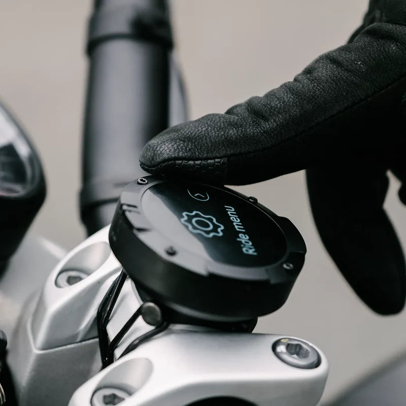 Beeline Moto II motorcycle navigation device side profile with gloved hand operating ride menu