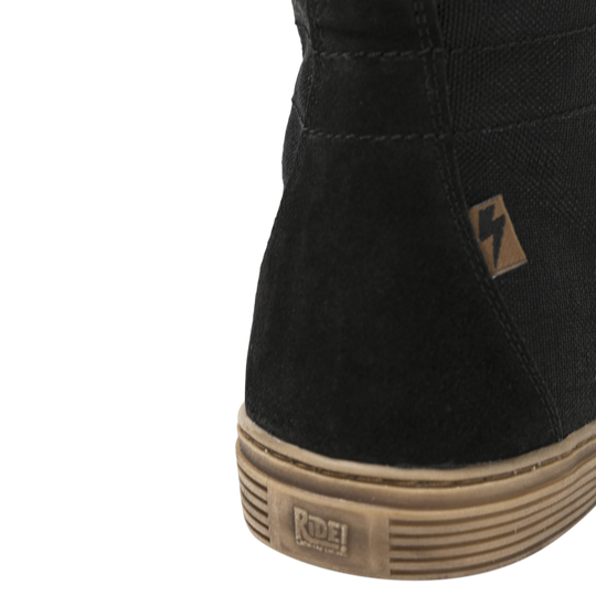 Close-up of the John Doe Neo Black high-top Trainer with logo tab and Ride! branding on the sole