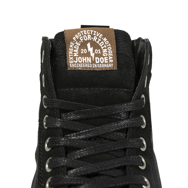 Close-up of the John Doe Neo Black high-top Trainer tongue with branded label and lace detail