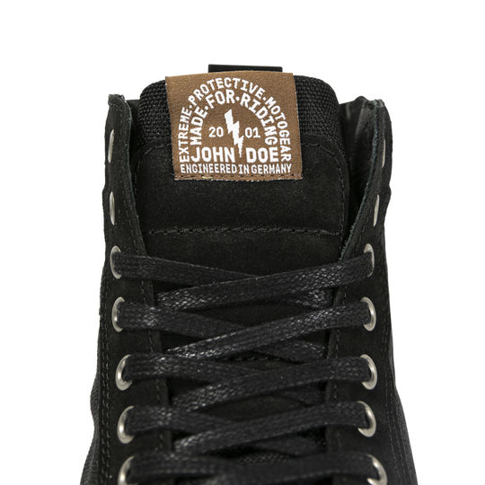 Close-up of the John Doe Neo Black high-top Trainer tongue with branded label and lace detail