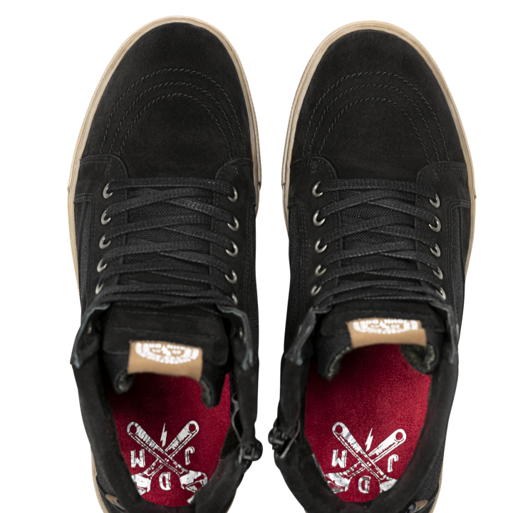 Top-down view of John Doe Neo Black Trainers showing red insoles with white WCDC logo