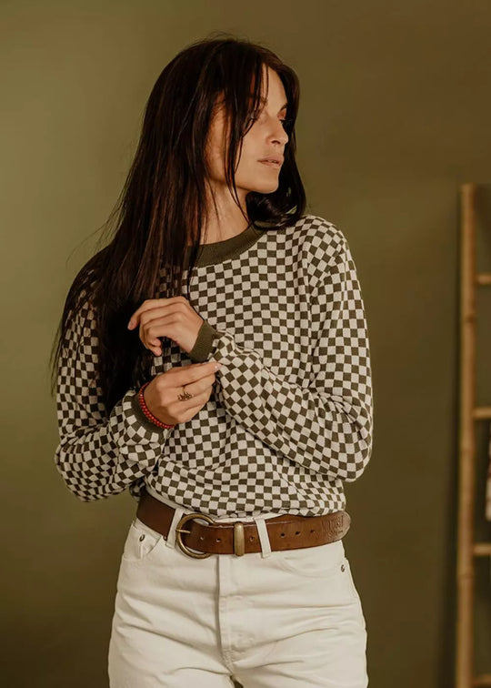 Model wearing the Wildust Sisters Vintage Racing Jumper in Khaki with a timeless vintage-inspired chequered knit
