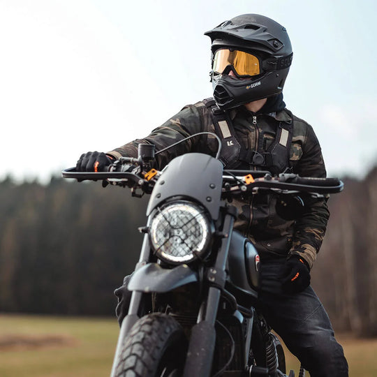 Front view of rider wearing Kriega Backpack R20, sat on motorcycle in forested area