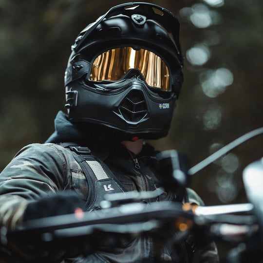 Closeup front view of rider wearing Kriega Backpack R20 with copper Goggles and black helmet