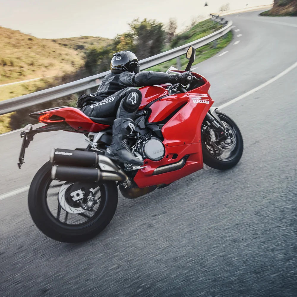 Kriega R3 Waistpack in use on a red Ducati sportbike, rider on a scenic road