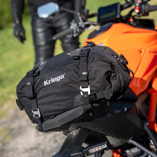 Kriega US-20 Drypack mounted on an orange KTM motorcycle, parked outdoors