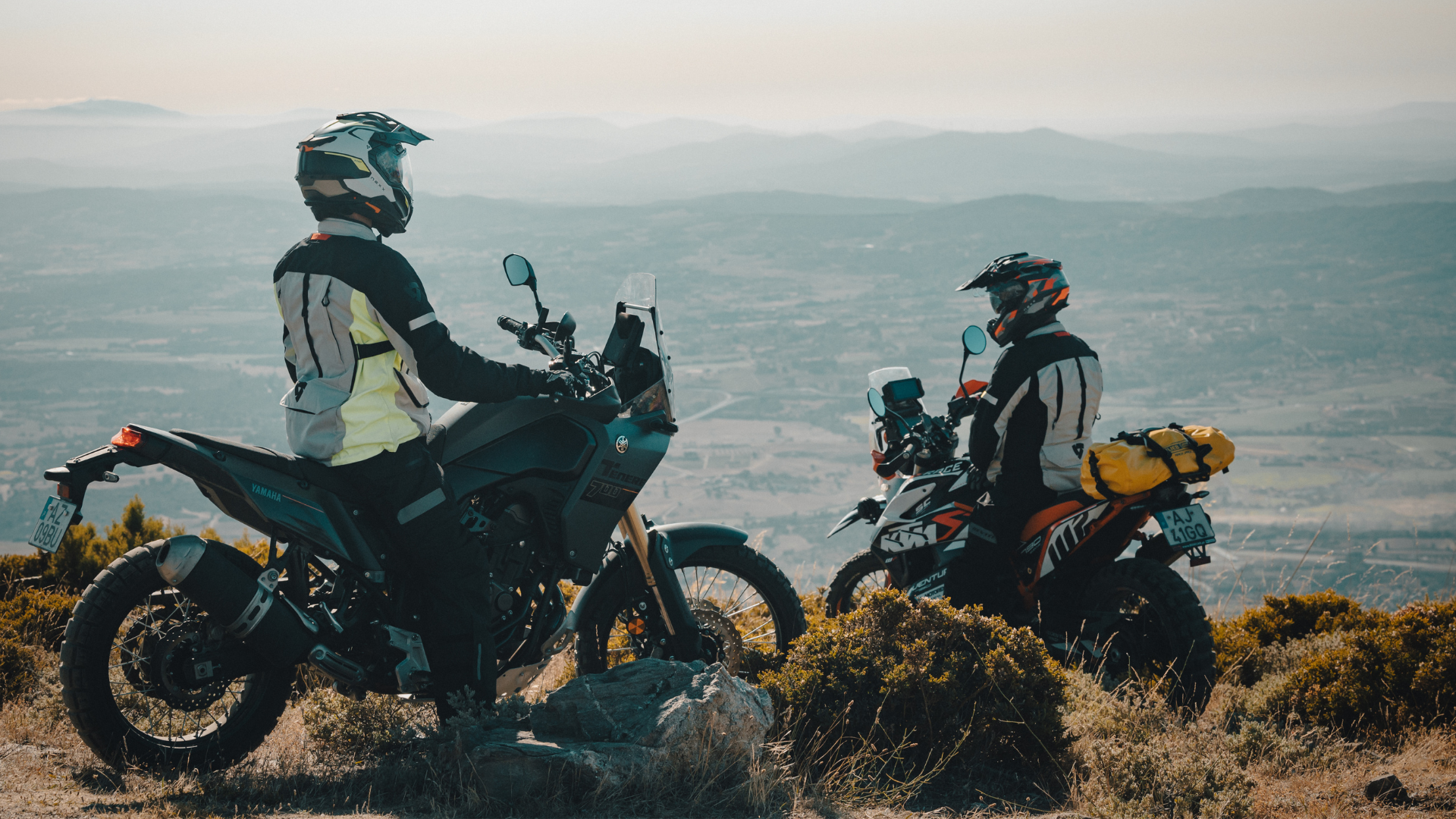Two-Riders-Wearing-Nexx-Adventure-Helmets-Looking-At-View-Motorcycles