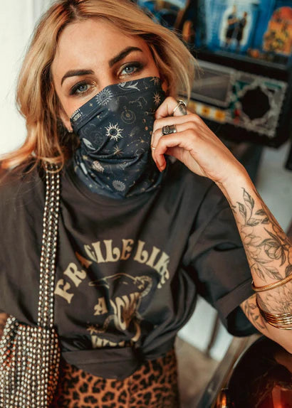 Woman wearing the Wildust Neck Tube Moonchild in dark grey with floral tattoo.