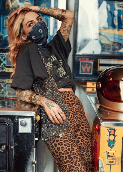 Woman wearing the Wildust Neck Tube Moonchild in dark grey — lifestyle rider photo.