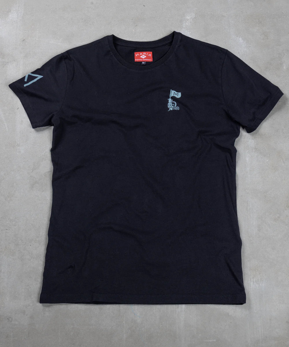 Black t-shirt with small logo on a gray concrete surface