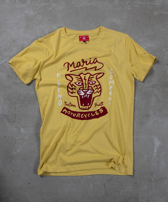 Yellow t-shirt with red graphic design on a gray surface