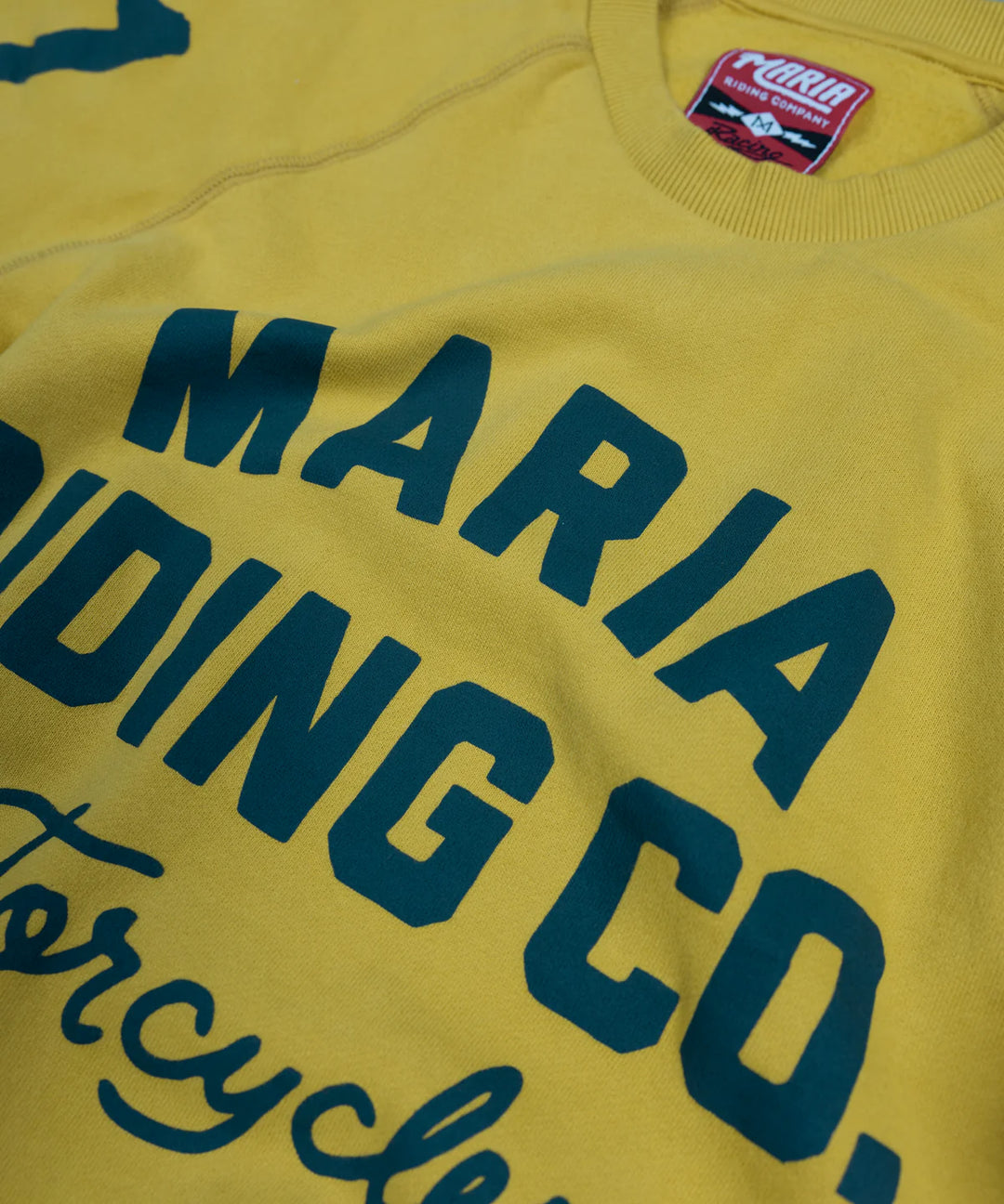 maria-riding-mustrad-yellow-spades-sweatshirt-close-up-front-print