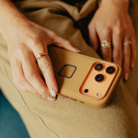 Peak Design Mobile Everyday Case for iPhone 17 Pro in Tan, held in hand