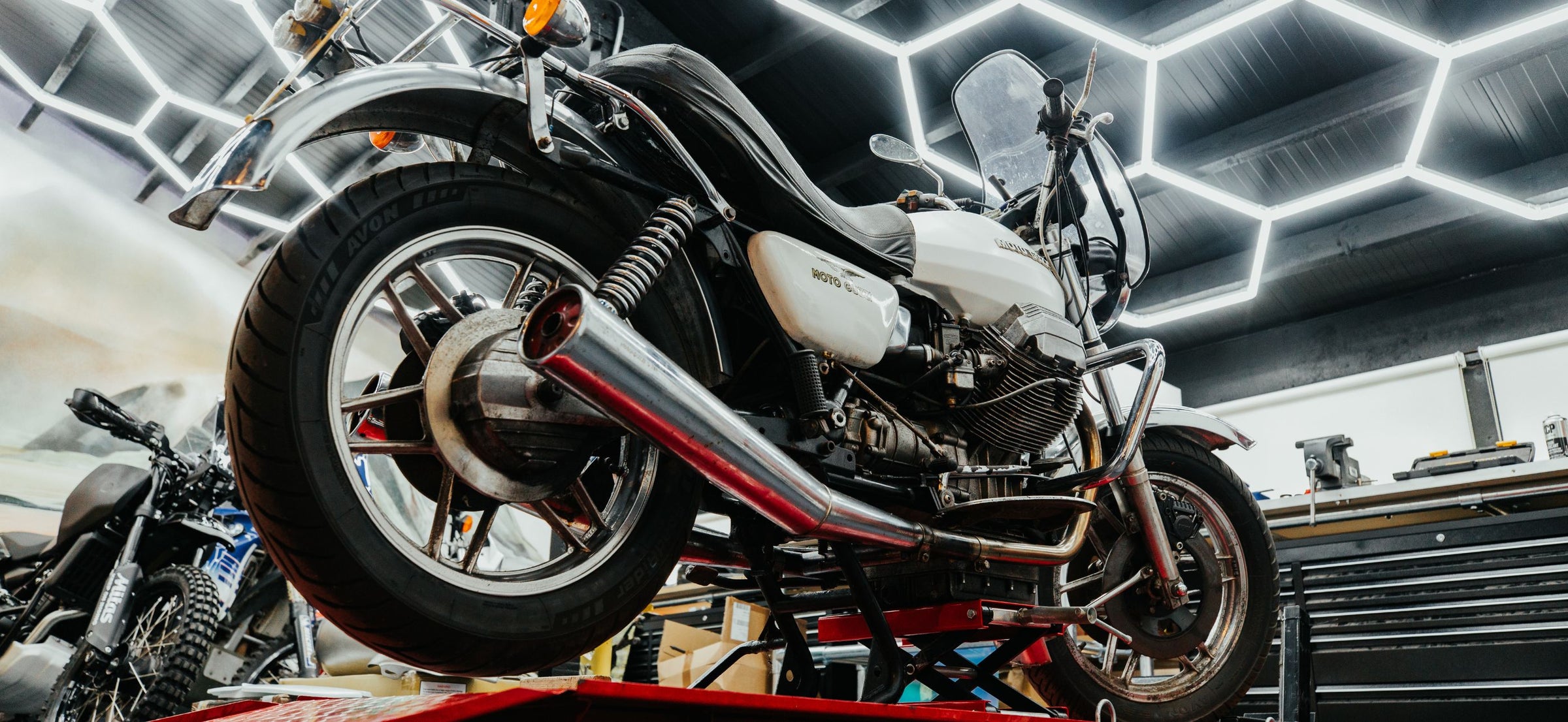 Custom Moto Guzzi on lift during workshop service at Machinehead Moto — example of hands-on bike tuning and modification