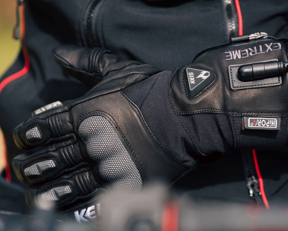 Close-up of Keis G901 Extreme Heated Gloves showing wrist connector and Hipora waterproof label.