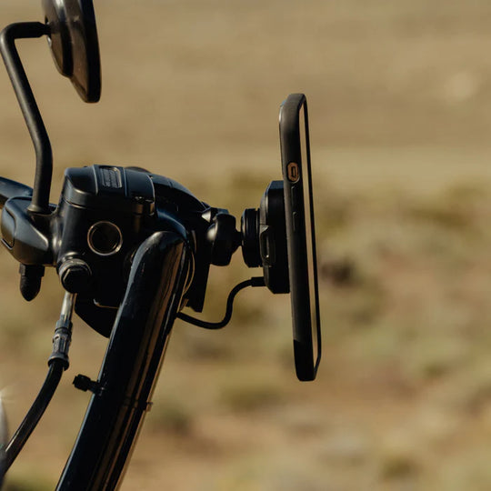 Peak Design motorcycle brake and clutch phone mount with charging module installed
Descriptive