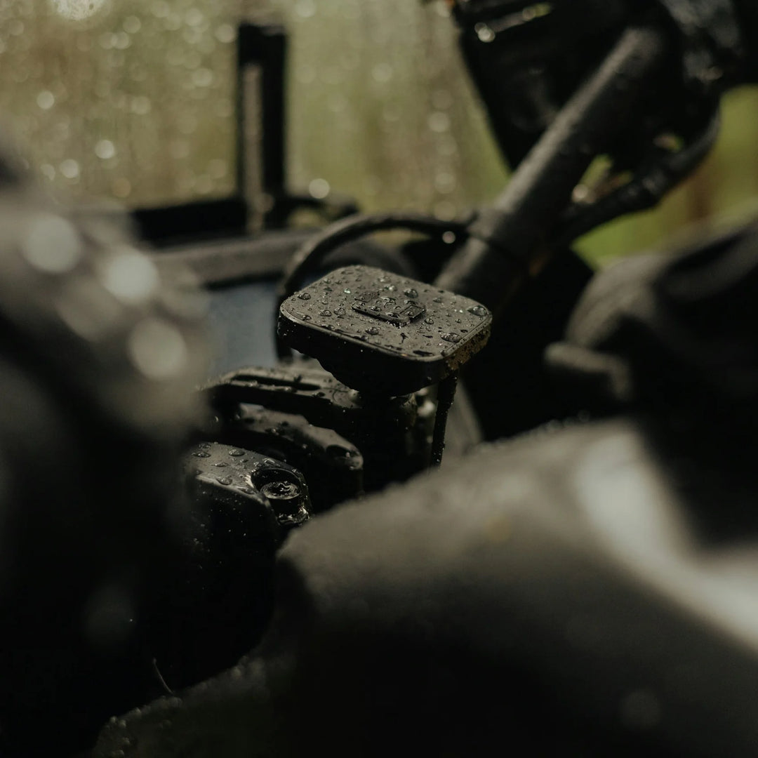 Peak Design charging motorcycle bar mount installed on handlebars in rainy conditions