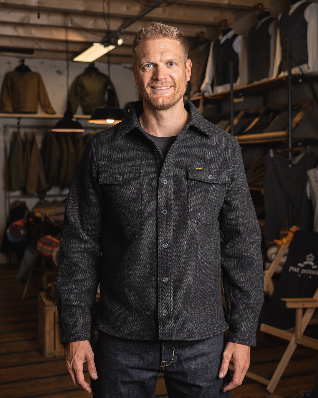 Model wearing the Pike Brothers 1943 CPO Shirt Atlanta Grey in a shop setting
