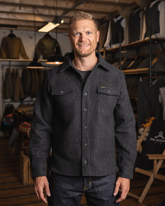 Model wearing the Pike Brothers 1943 CPO Shirt Atlanta Grey in a shop setting