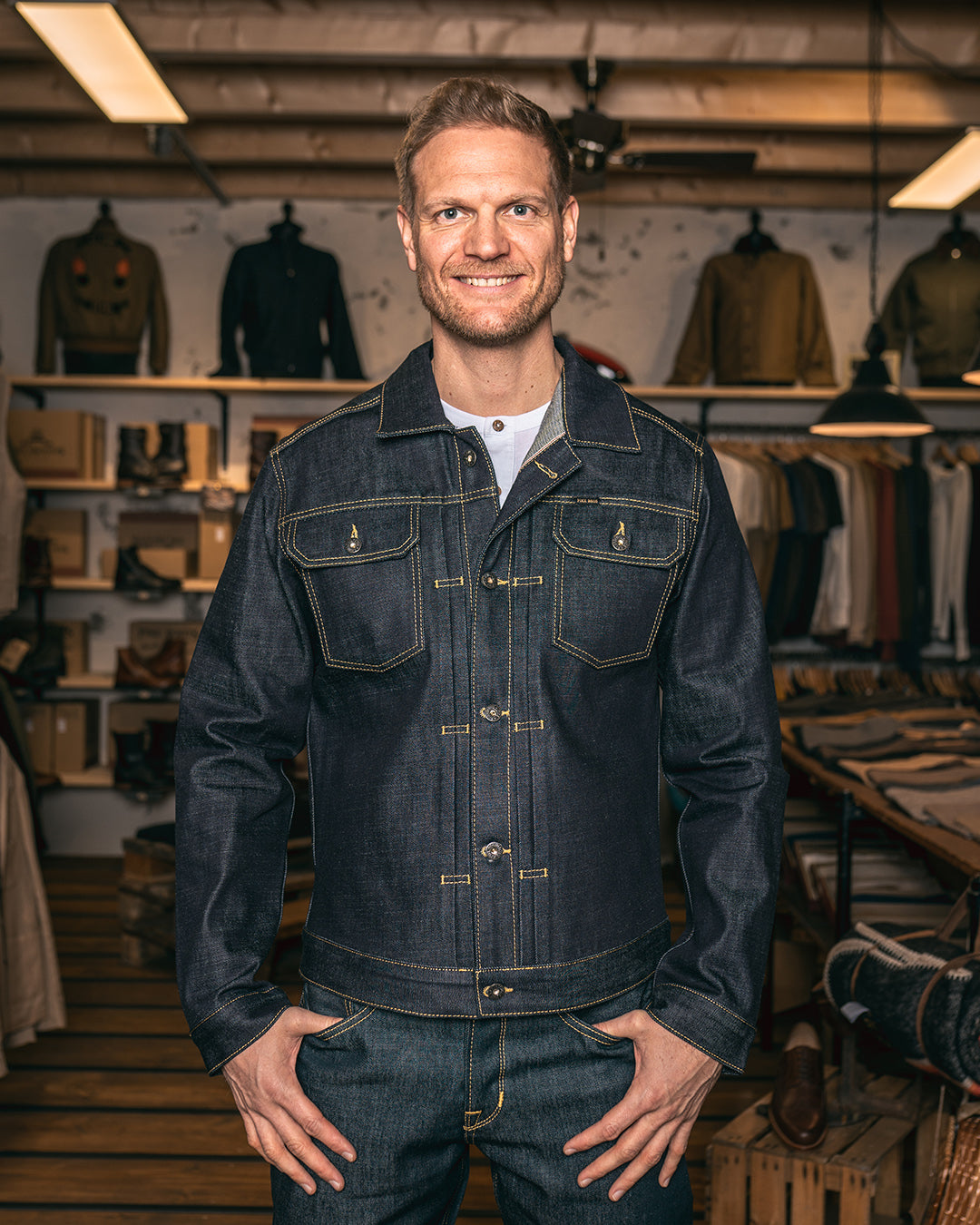 Model wearing Pike Brothers 1958 Roamer Jacket in 15oz indigo denim, front view styled with raw denim Chopper Pants